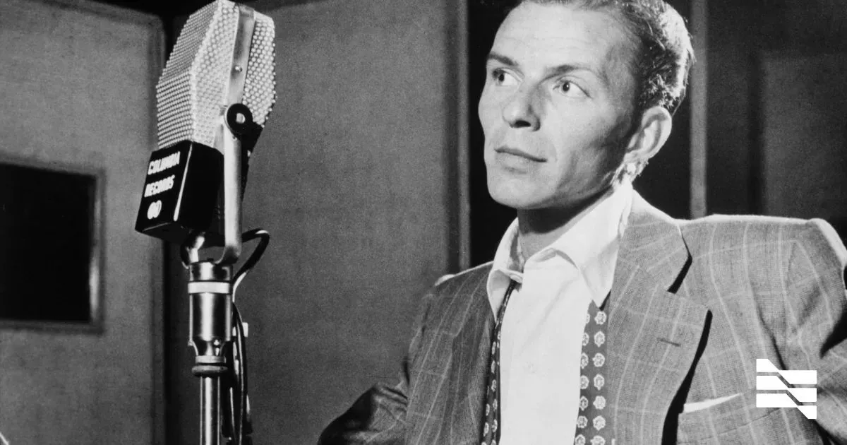 Vintage photo of a man in a suit speaking into a classic microphone, epitomizing personal branding for freelancers.